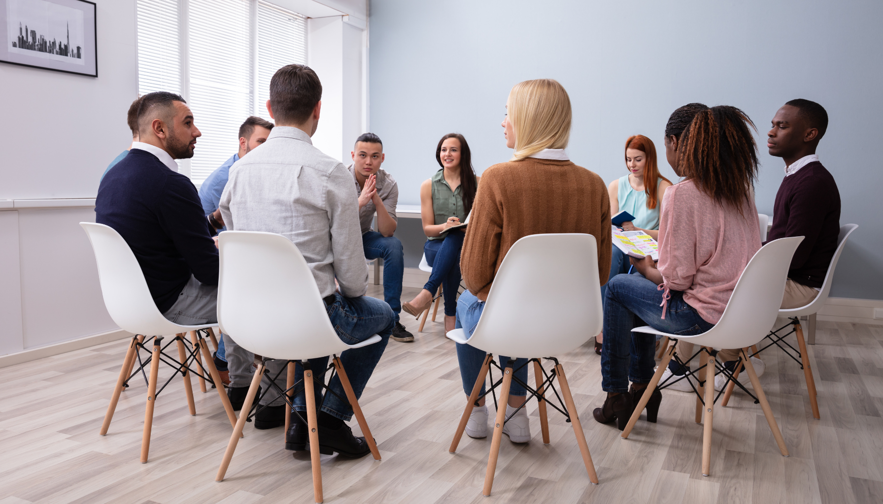 This image portrays a serene church setting where diverse leaders are engaged in thoughtful discussions about LGBTQ+ inclusion. The clean, bright room is free from distraction, yet warm and welcoming. Ideal for promoting church coaching programs focused on LGBTQ+ inclusion.