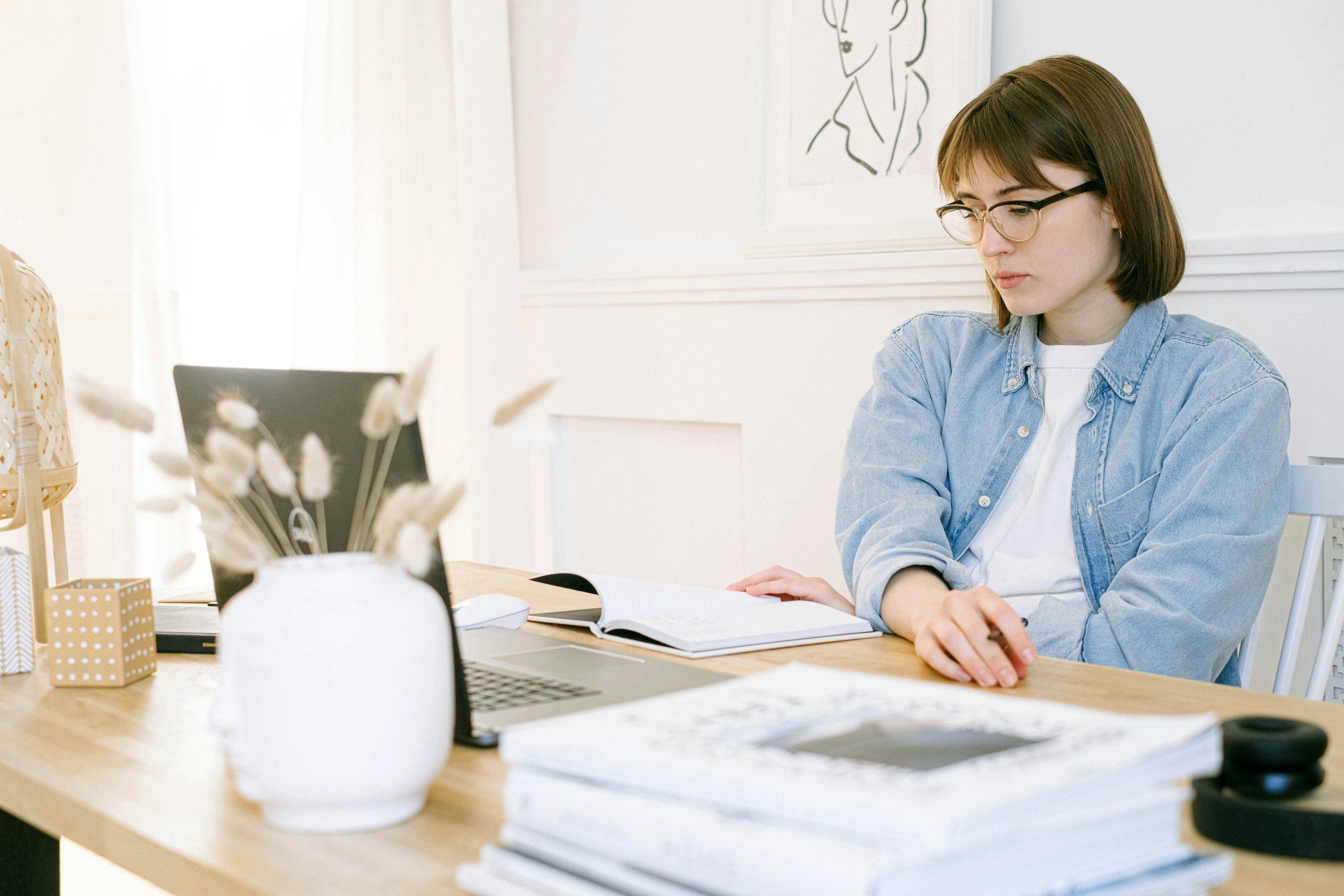 Woman attending a webinar and taking notes